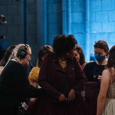 Costume students checking actor costumes